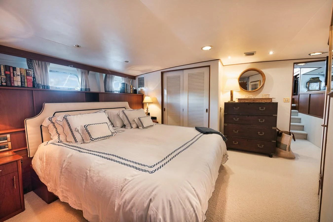 a bedroom with a bed and a dresser aboard SHARK Yacht for Sale