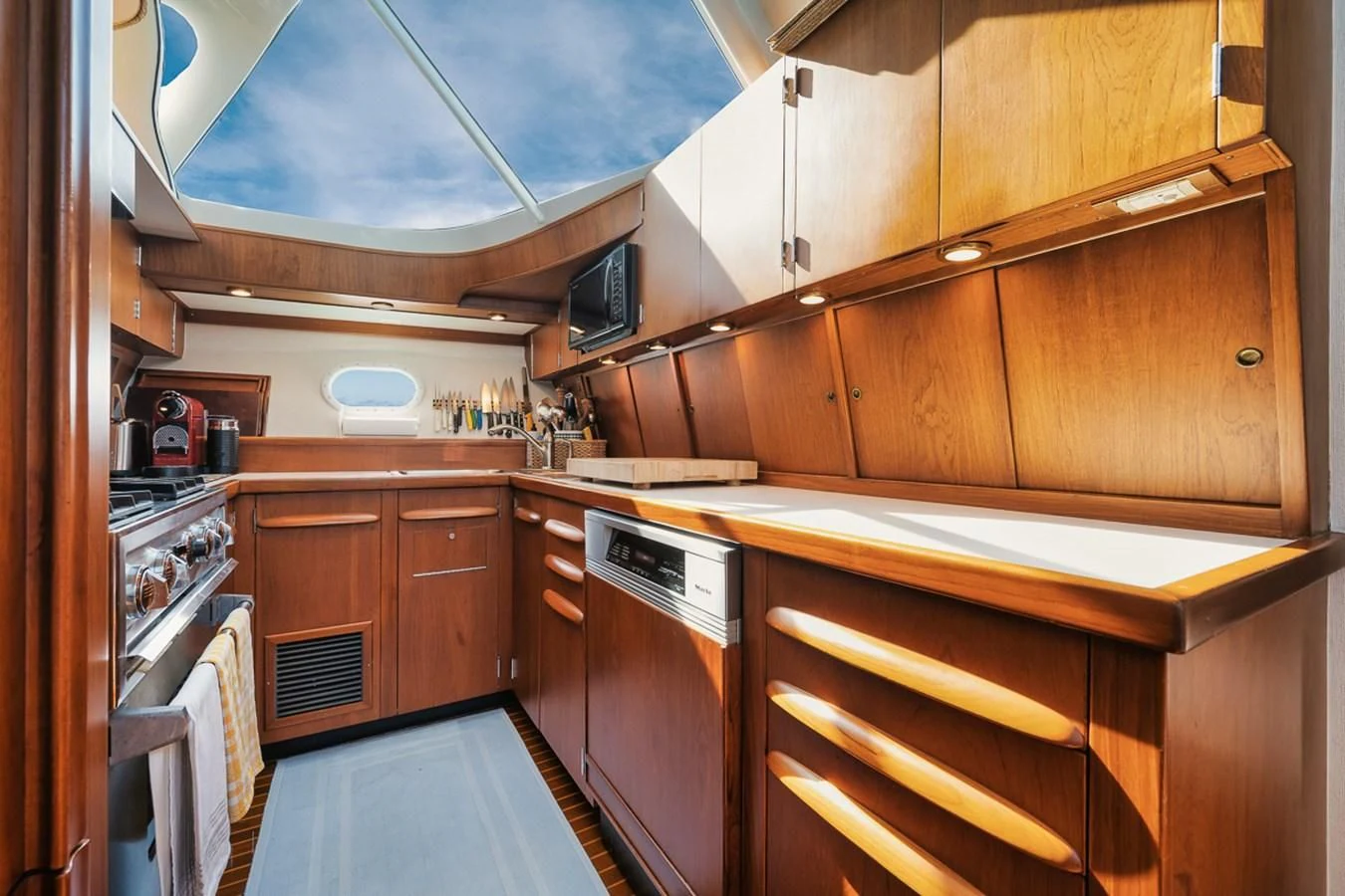 a kitchen with wooden cabinets aboard SHARK Yacht for Sale