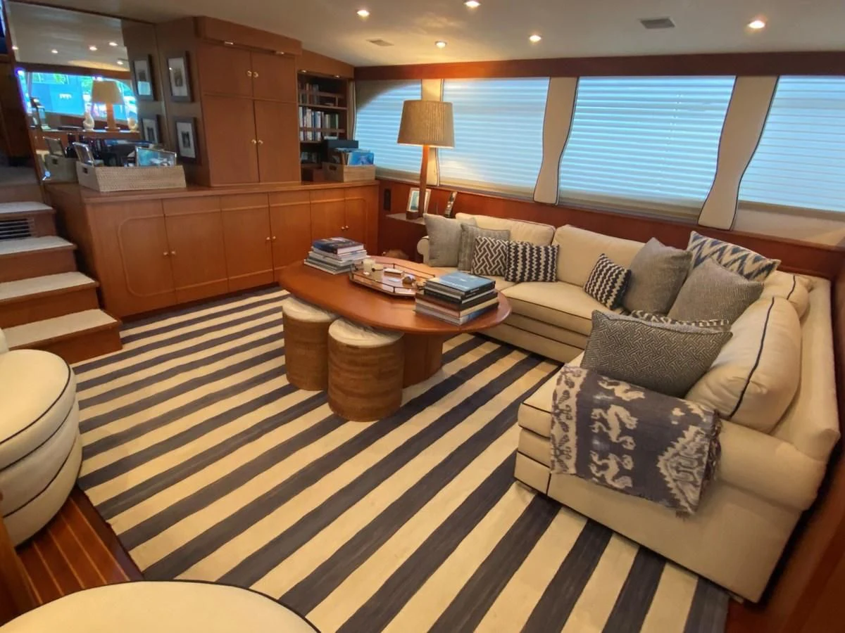a living room with a couch and a coffee table aboard SHARK Yacht for Sale