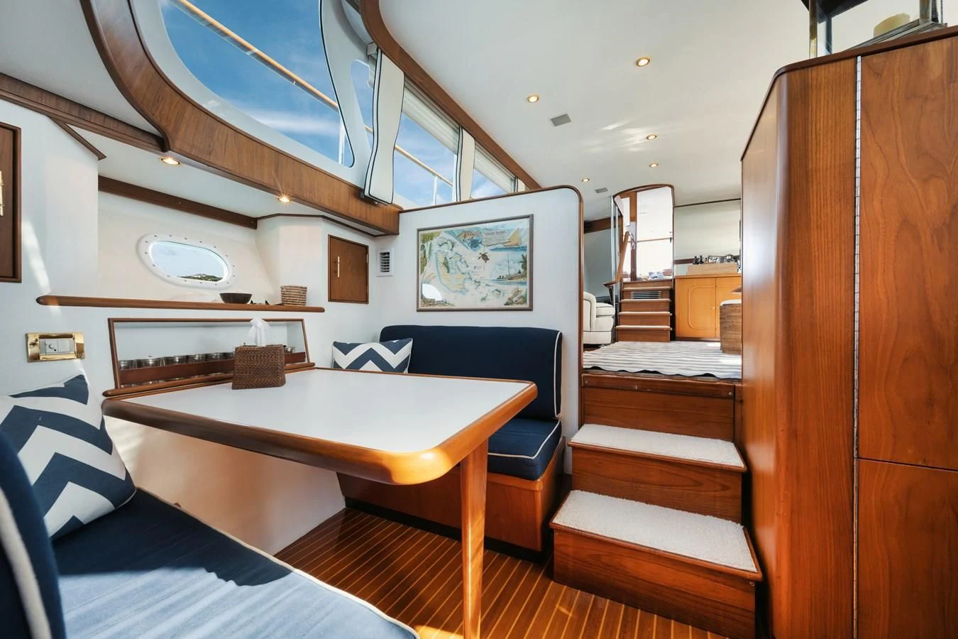 a room with a table and a bed aboard SHARK Yacht for Sale