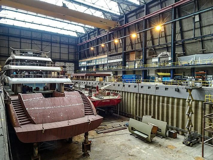 a large factory with several boats aboard PROJECT FAITH Yacht for Sale