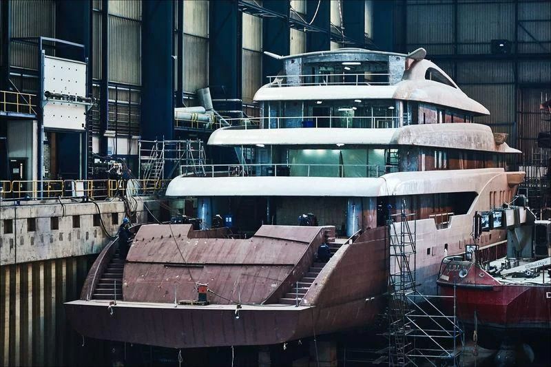 a large cruise ship docked aboard PROJECT FAITH Yacht for Sale