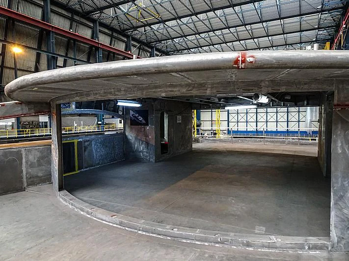 a large warehouse with a large metal beam above it aboard PROJECT FAITH Yacht for Sale