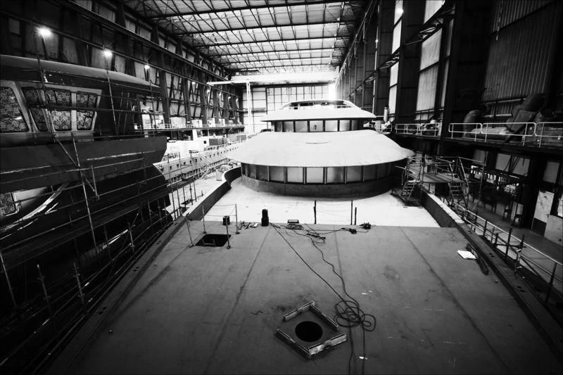 a large room with a large round table and chairs aboard PROJECT FAITH Yacht for Sale