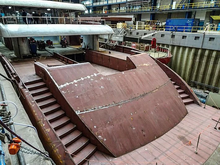 a large red rectangular object on a wooden surface aboard PROJECT FAITH Yacht for Sale