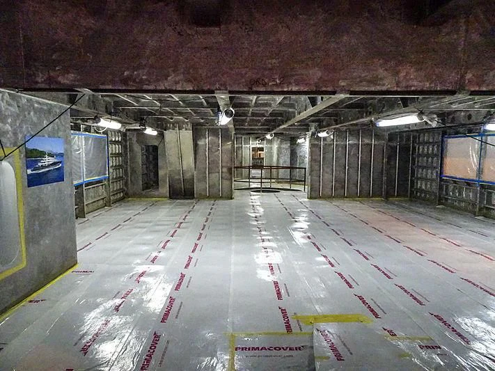 a large warehouse with many blue boxes aboard PROJECT FAITH Yacht for Sale