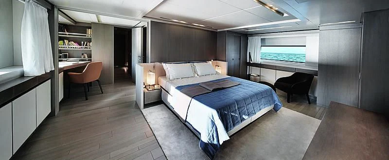 a room with a bed and desk aboard BLUE AGAVE Yacht for Sale