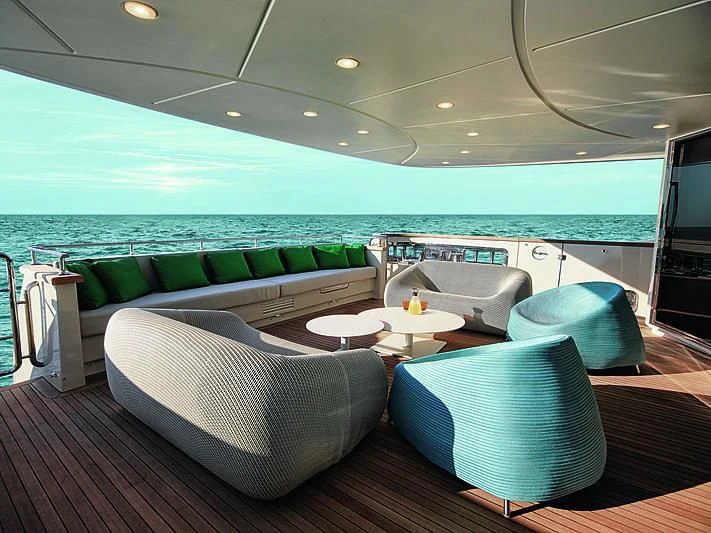 a room with a couch and a table and chairs aboard BLUE AGAVE Yacht for Sale