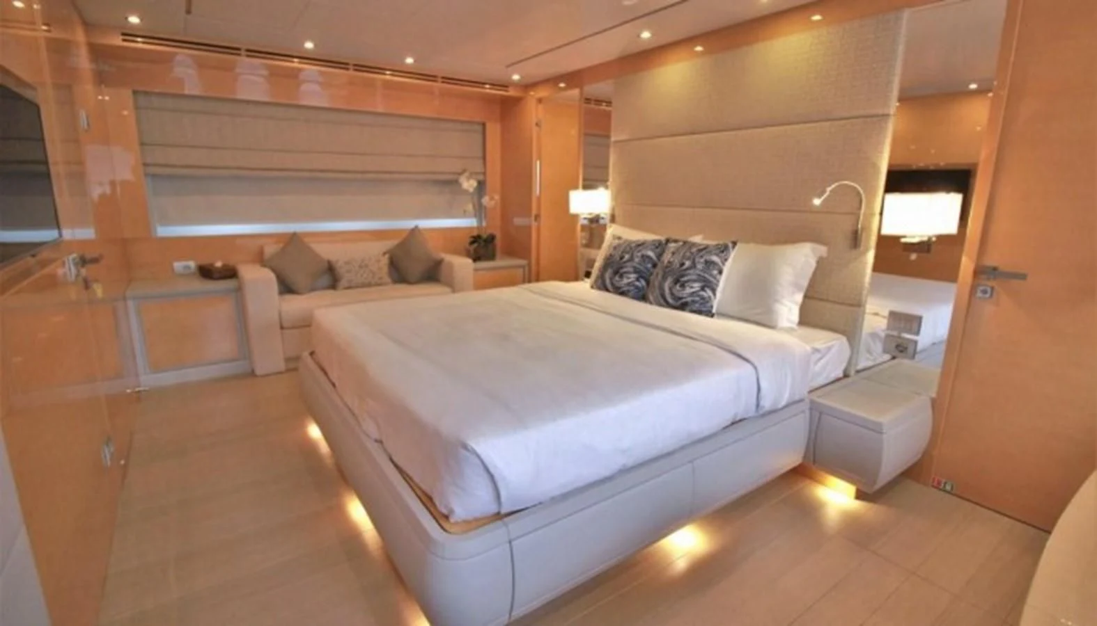 a room with a bed and a couch aboard VERSILCRAFT V86 Yacht for Sale
