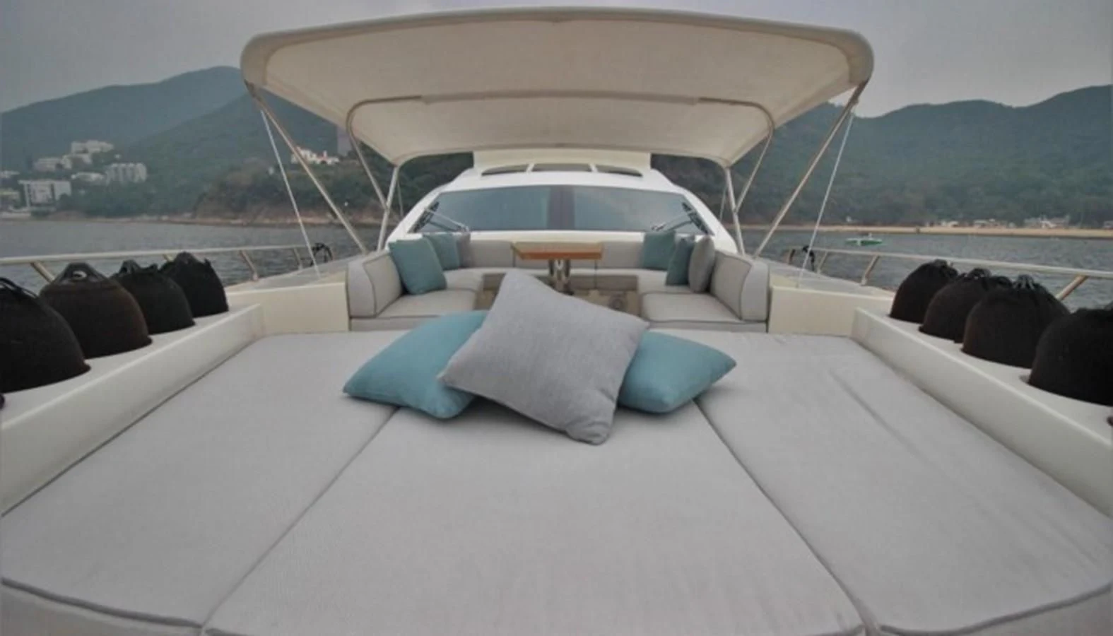 a white car with pillows on a white surface aboard VERSILCRAFT V86 Yacht for Sale