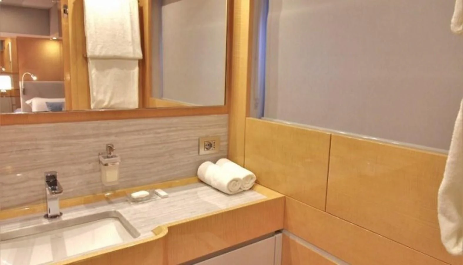 a bathroom with a countertop sink and mirror aboard VERSILCRAFT V86 Yacht for Sale