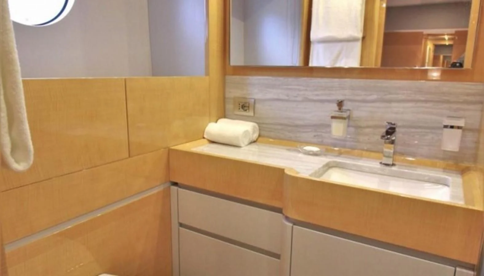 a bathroom with a countertop sink and mirror aboard VERSILCRAFT V86 Yacht for Sale