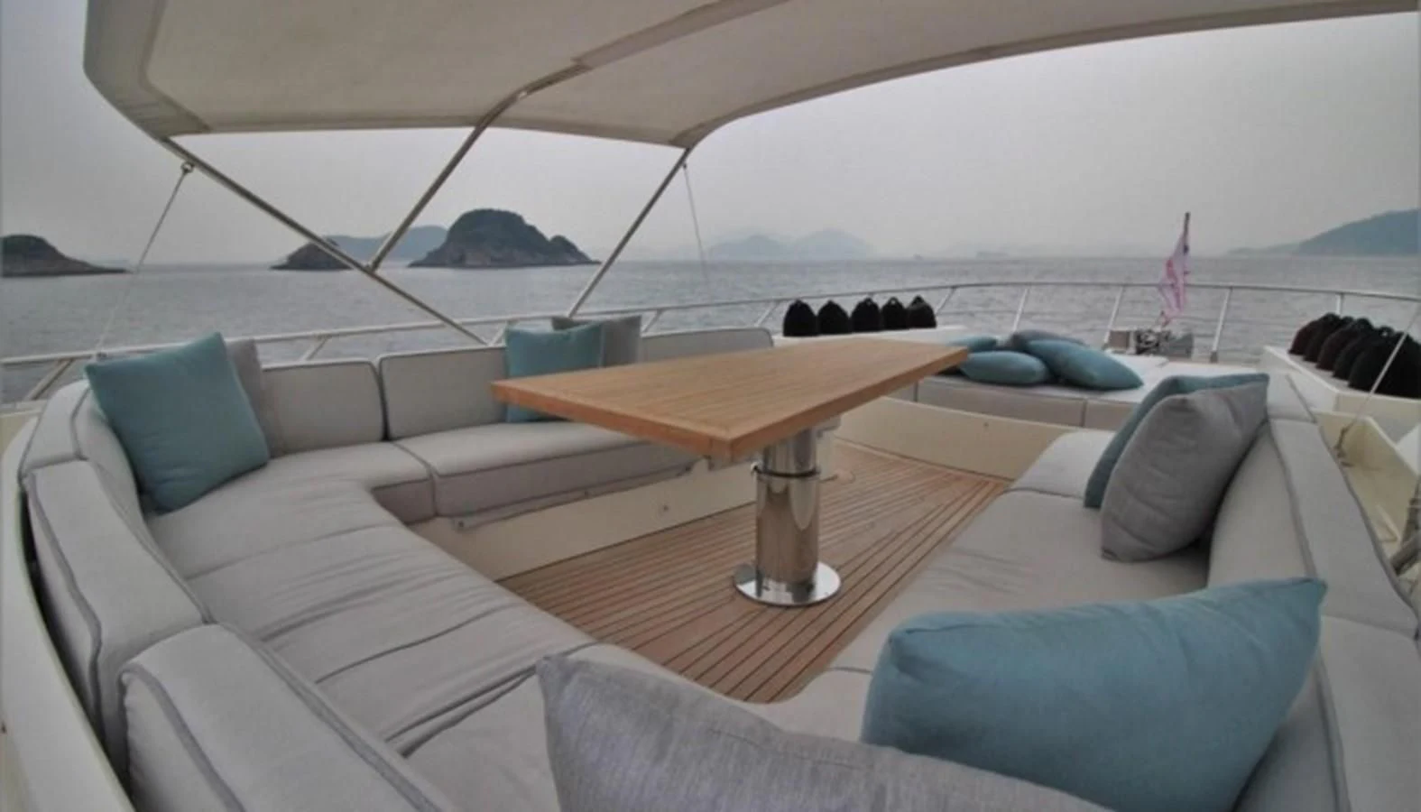 a lounge area with a table and chairs aboard VERSILCRAFT V86 Yacht for Sale