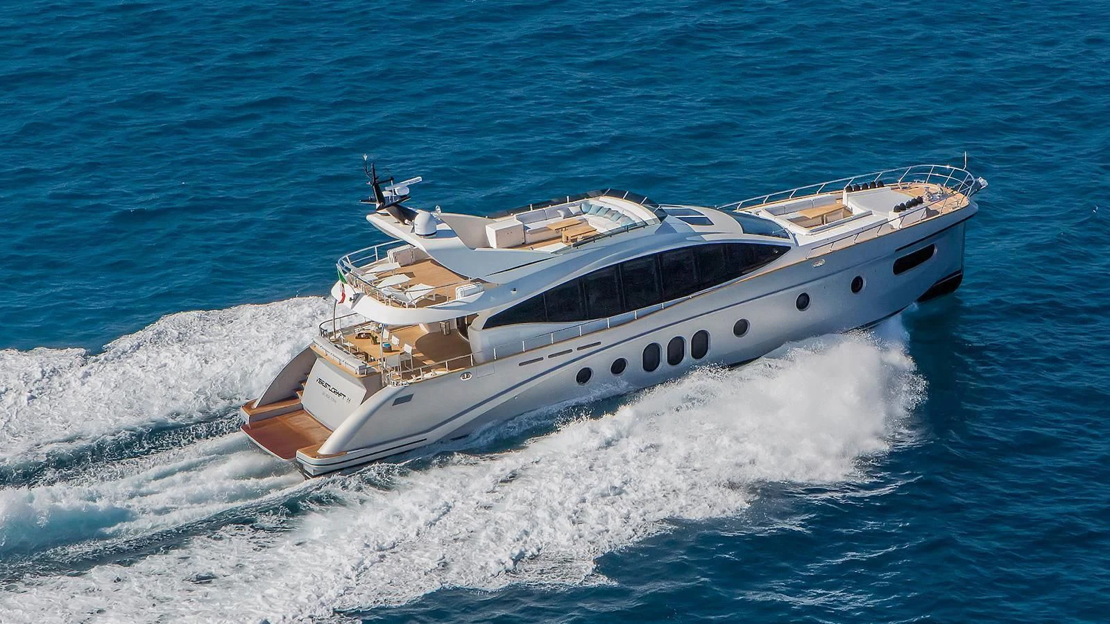 a white yacht on the water aboard VERSILCRAFT V86 Yacht for Sale