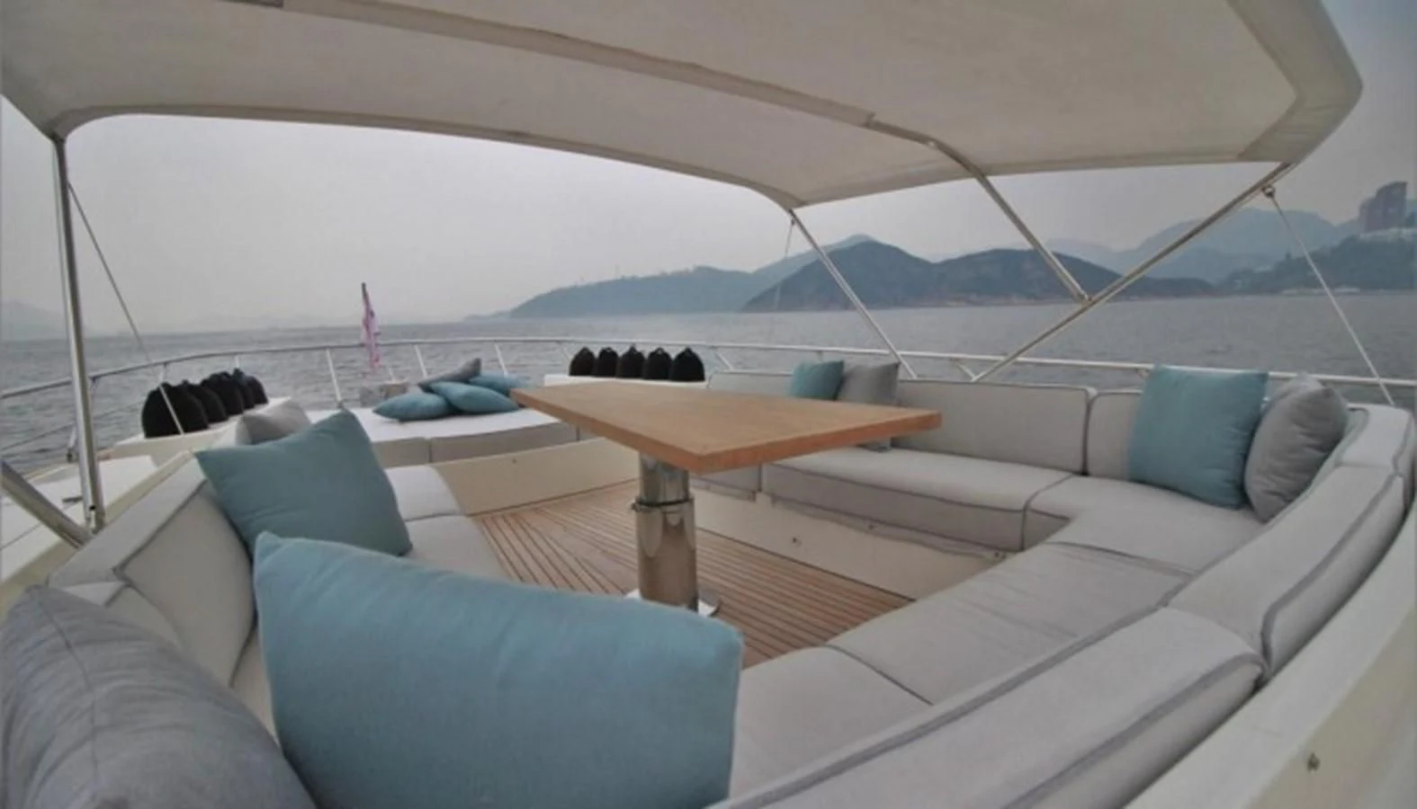 a couch and a table on a boat aboard VERSILCRAFT V86 Yacht for Sale
