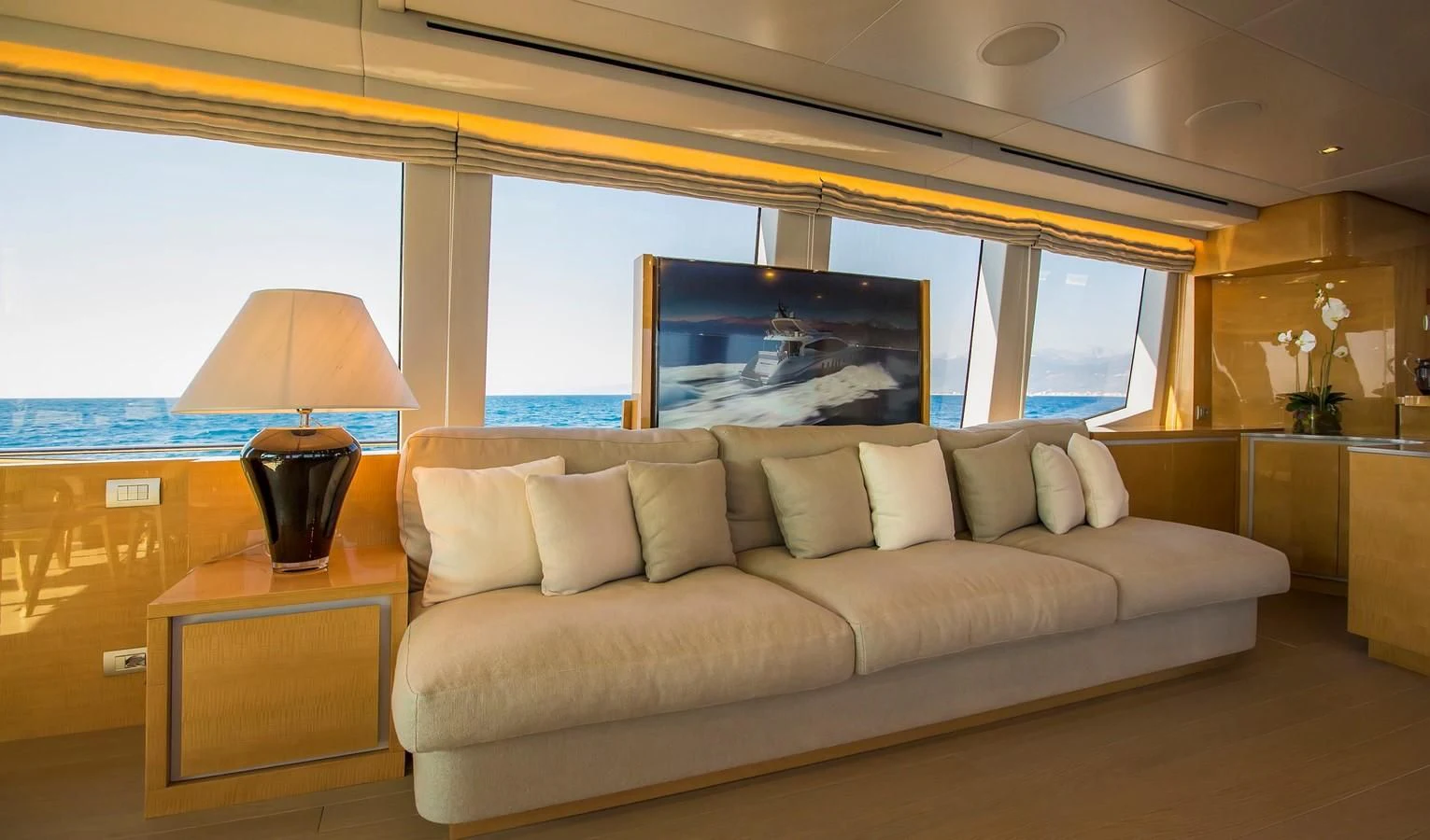 a living room with a large window aboard VERSILCRAFT V86 Yacht for Sale