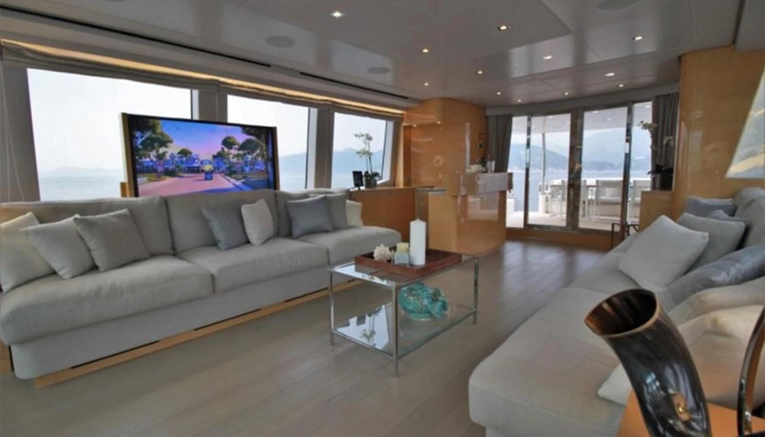 a living room with a large screen aboard VERSILCRAFT V86 Yacht for Sale