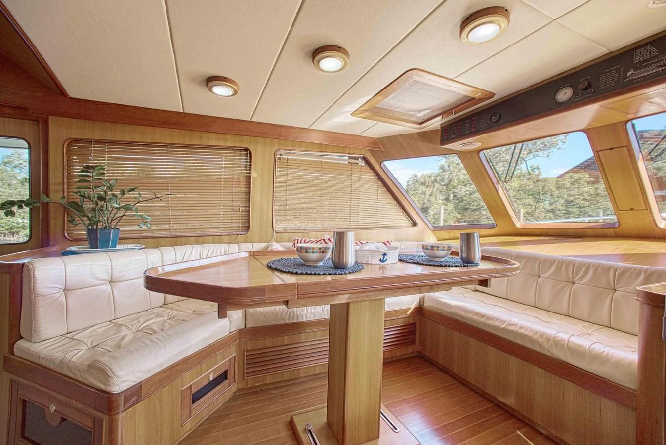 a table and couch in a room aboard DISCONNECTED Yacht for Sale