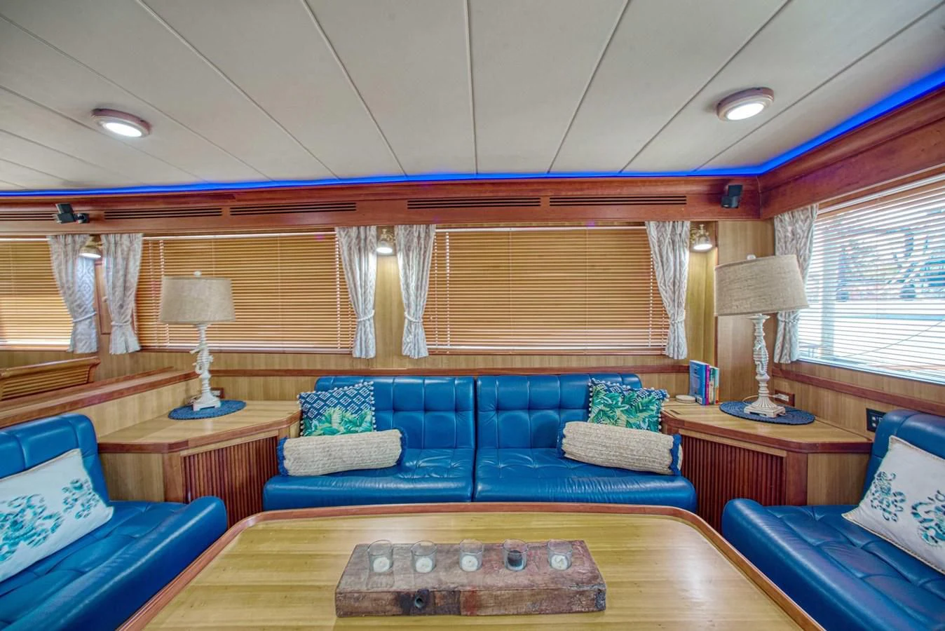 a living room with blue couches aboard DISCONNECTED Yacht for Sale