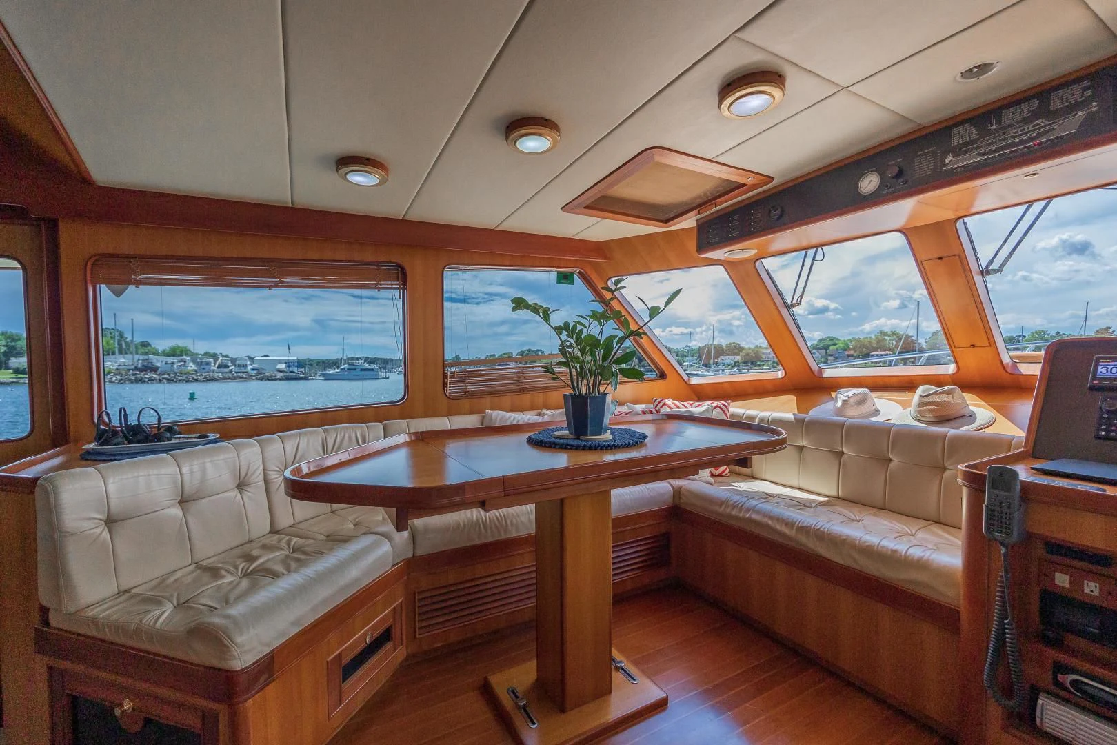 a living room with a table and couches aboard DISCONNECTED Yacht for Sale