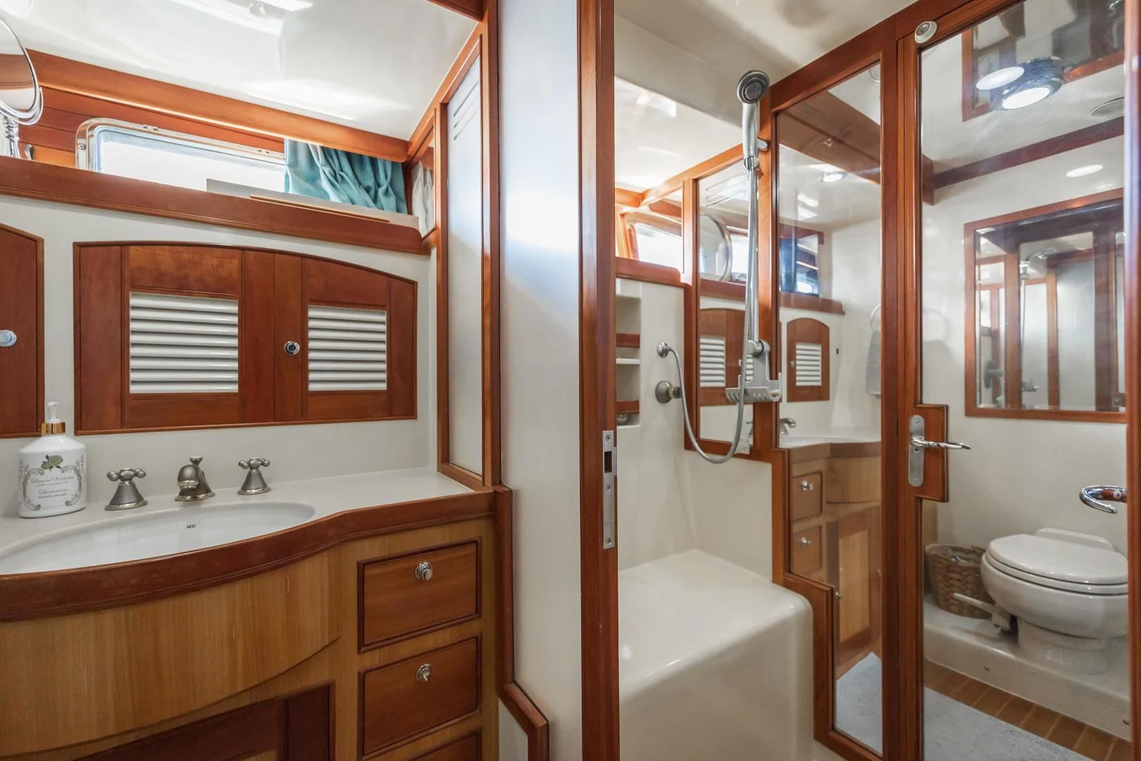 a bathroom with a toilet and a sink aboard DISCONNECTED Yacht for Sale