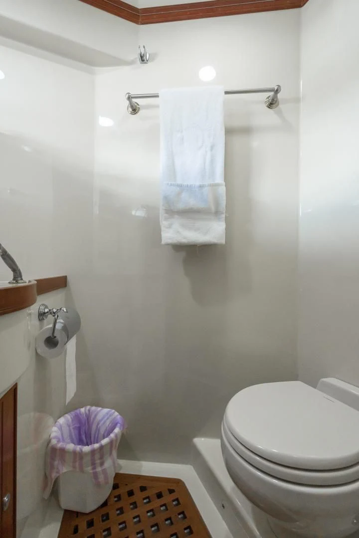 a bathroom with a shower curtain aboard DISCONNECTED Yacht for Sale