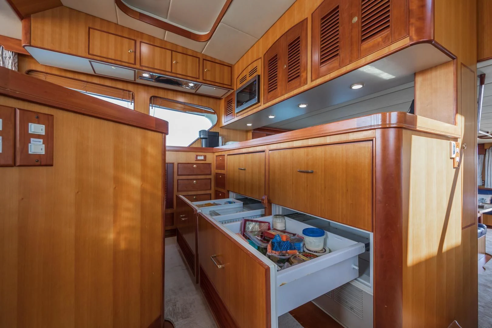 a kitchen with wooden cabinets aboard DISCONNECTED Yacht for Sale