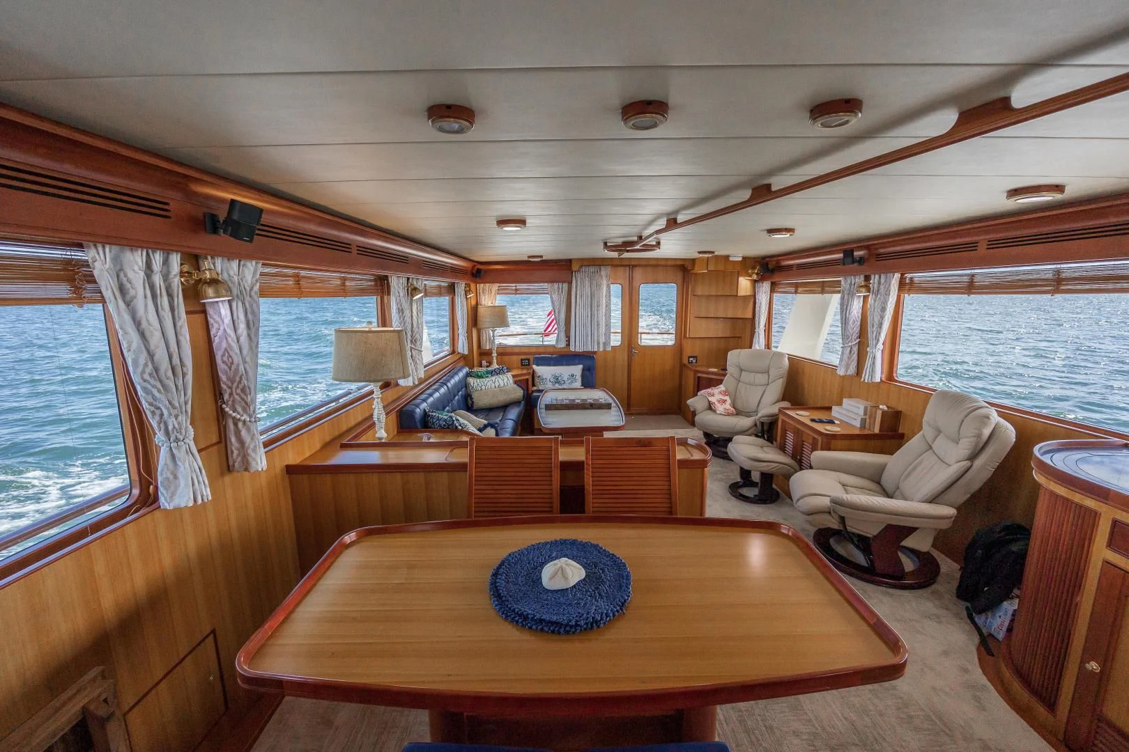 a boat with a table and chairs aboard DISCONNECTED Yacht for Sale