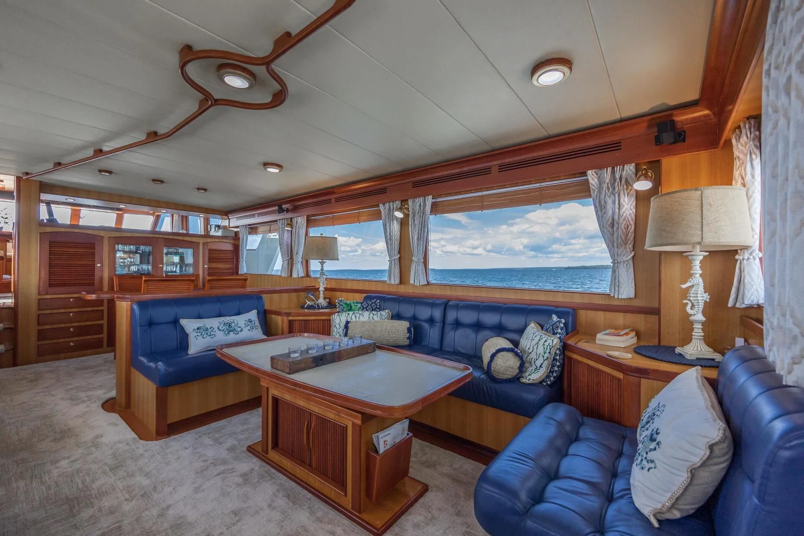 a living room with a table and couches aboard DISCONNECTED Yacht for Sale