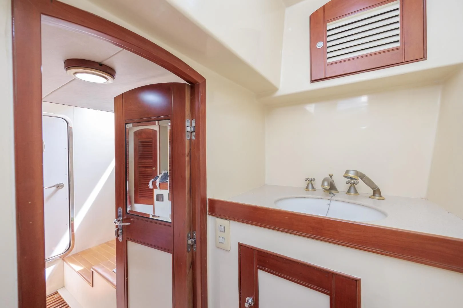 a bathroom with a sink and a mirror aboard DISCONNECTED Yacht for Sale