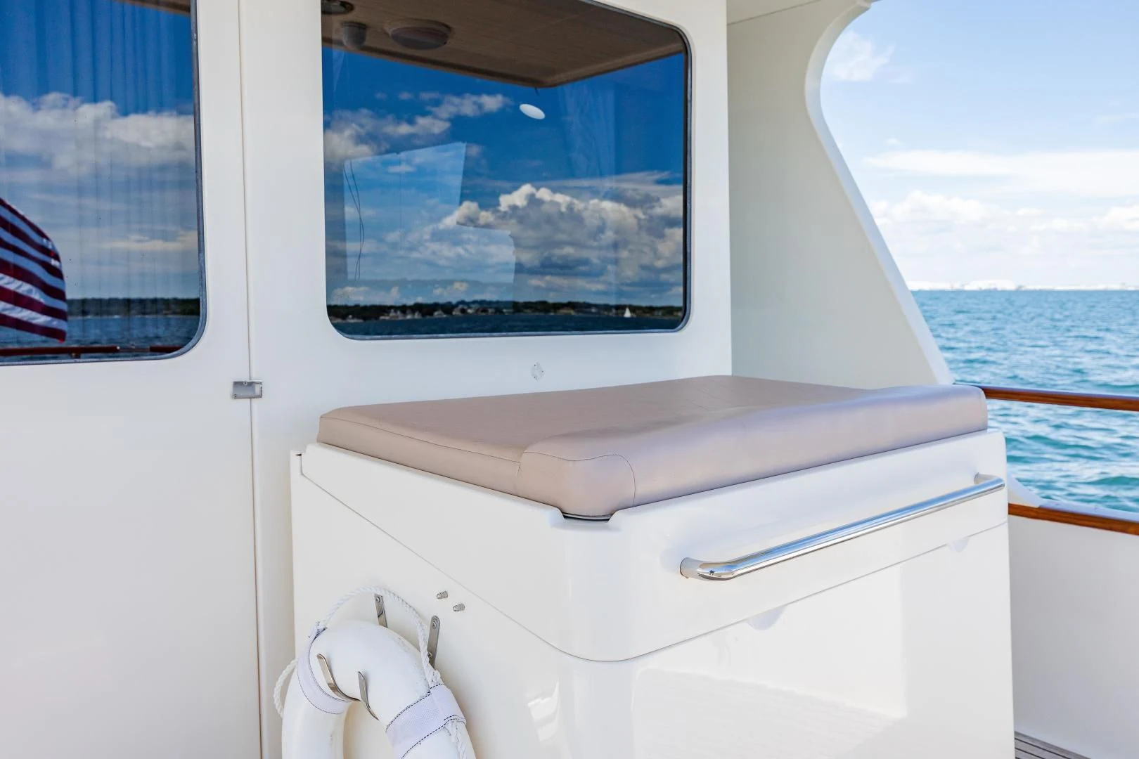 a window with a view of the ocean and land below aboard DISCONNECTED Yacht for Sale