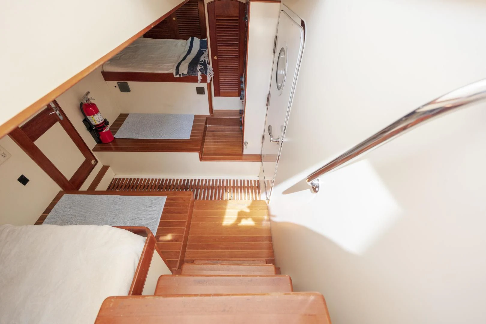 a room with a bed and a table aboard DISCONNECTED Yacht for Sale