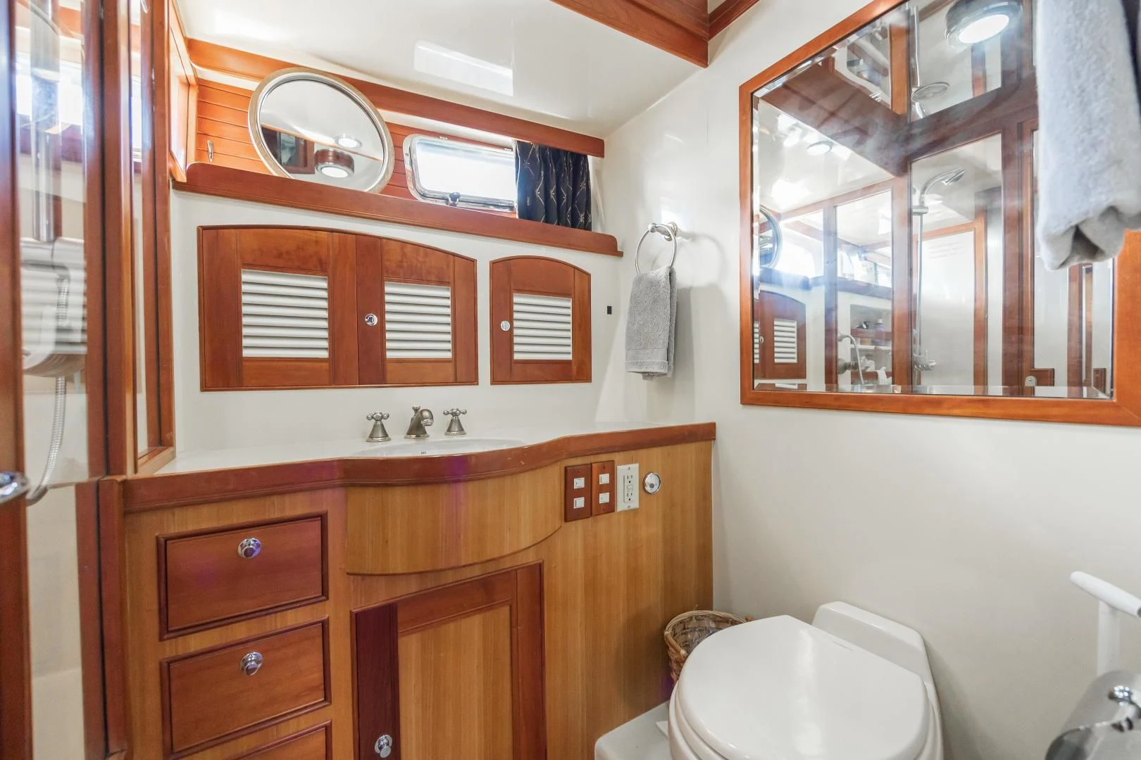 a bathroom with a toilet and a mirror aboard DISCONNECTED Yacht for Sale