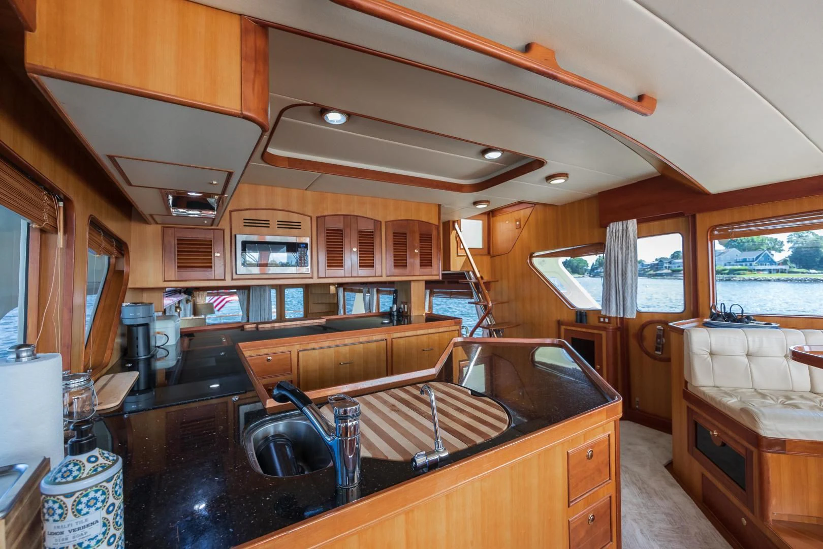 a kitchen with wooden cabinets aboard DISCONNECTED Yacht for Sale