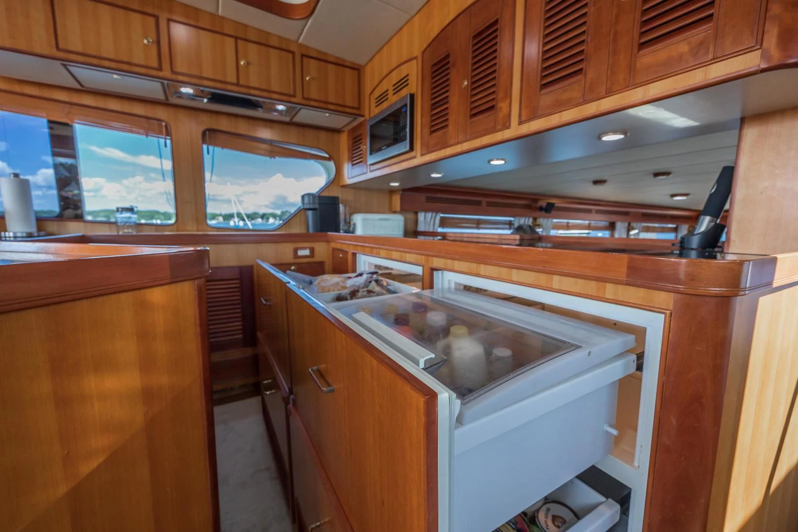 a kitchen with wooden cabinets aboard DISCONNECTED Yacht for Sale