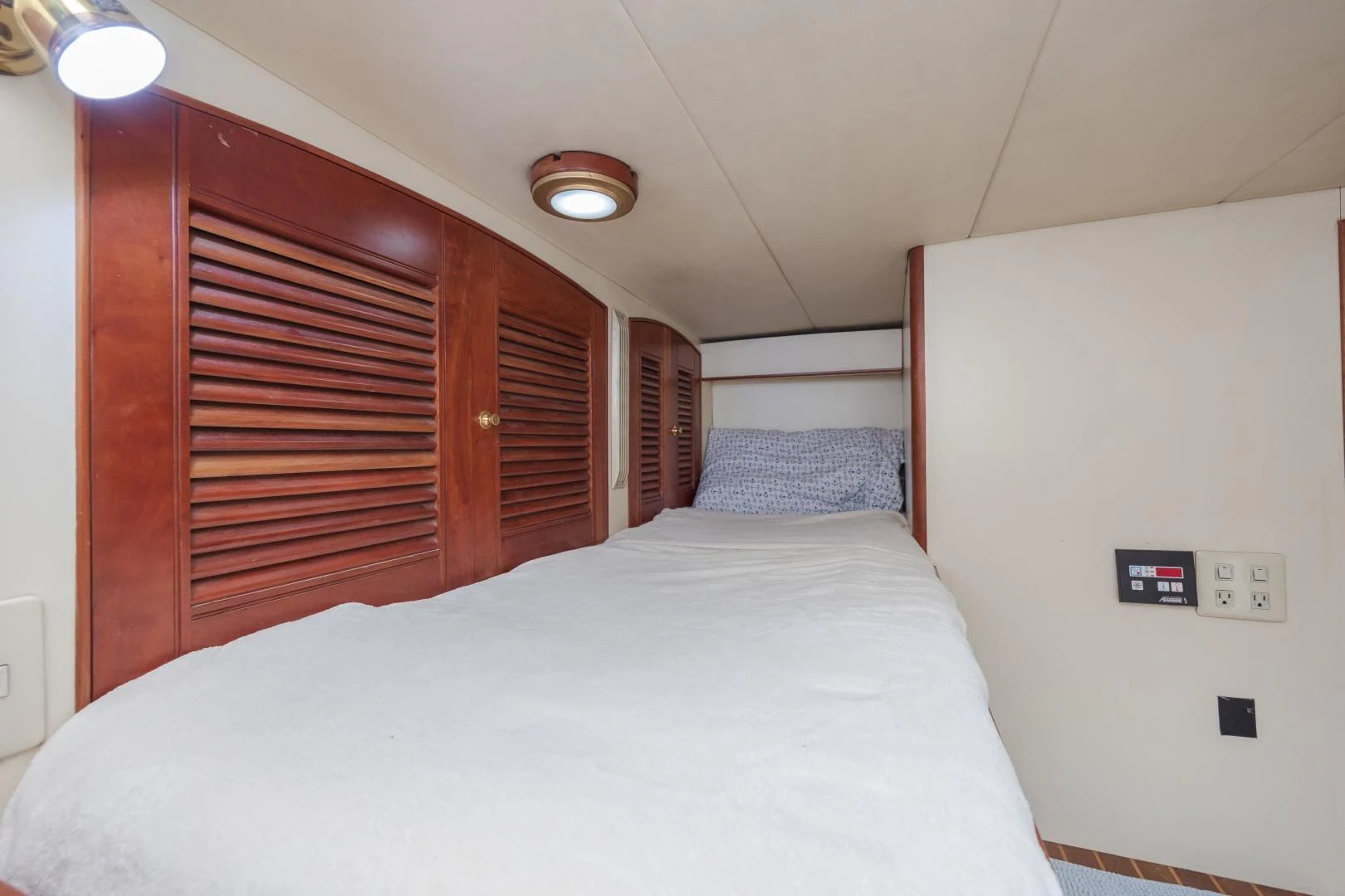 a bed with a white sheet aboard DISCONNECTED Yacht for Sale