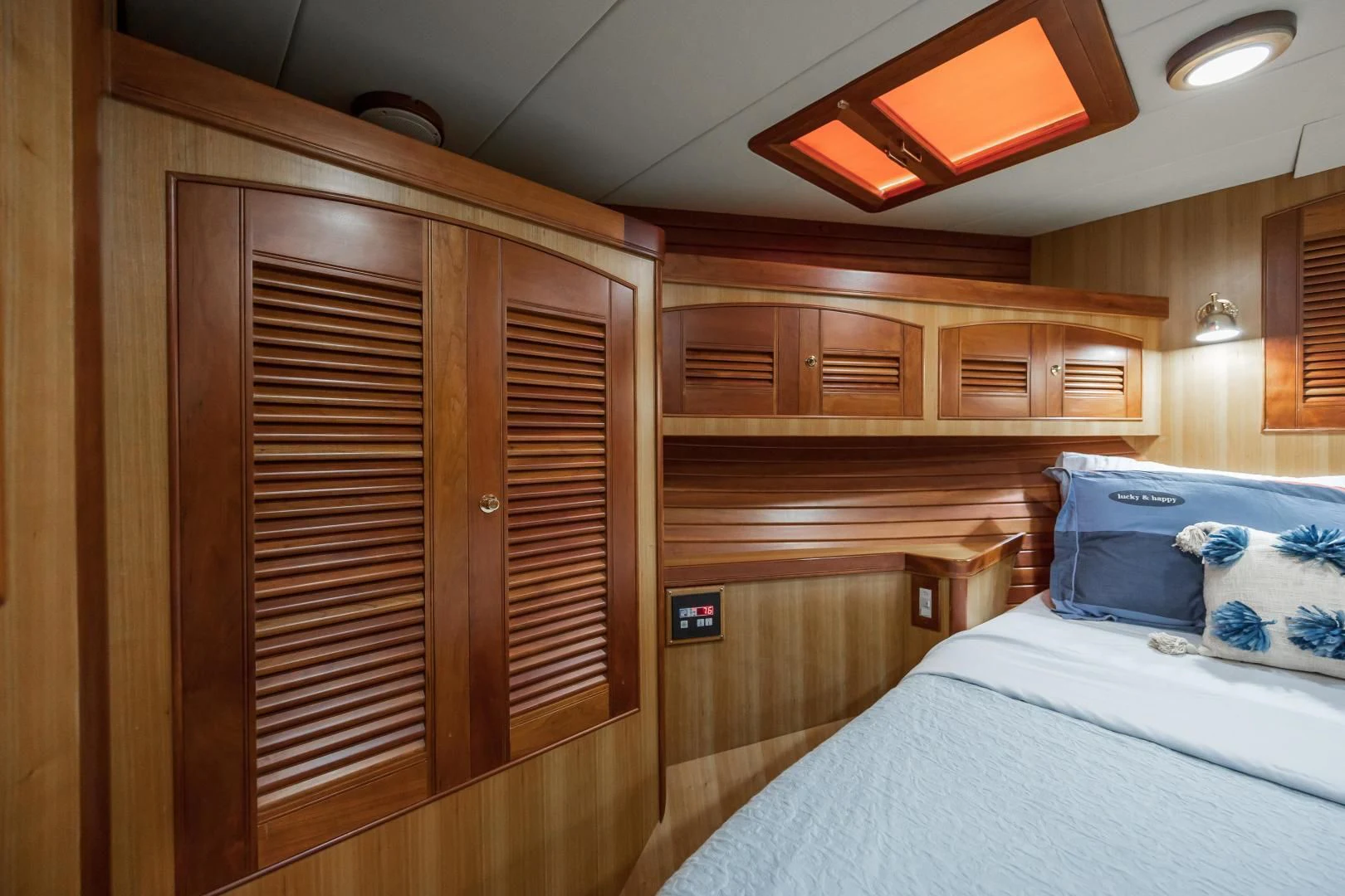 a room with a bed and a closet aboard DISCONNECTED Yacht for Sale