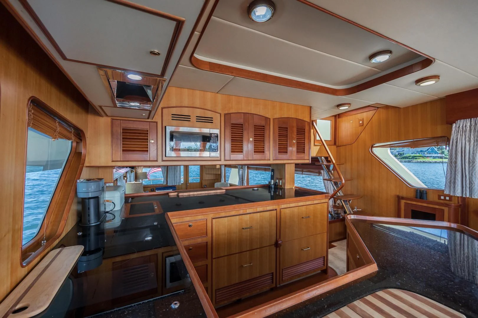 a kitchen with wooden cabinets aboard DISCONNECTED Yacht for Sale