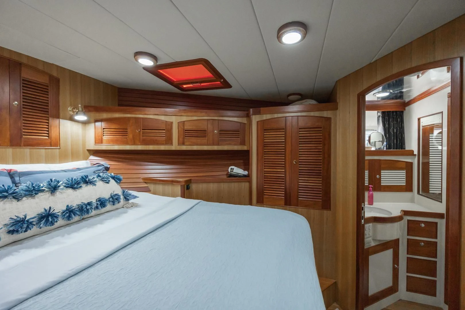 a room with wooden cabinets and a bed aboard DISCONNECTED Yacht for Sale