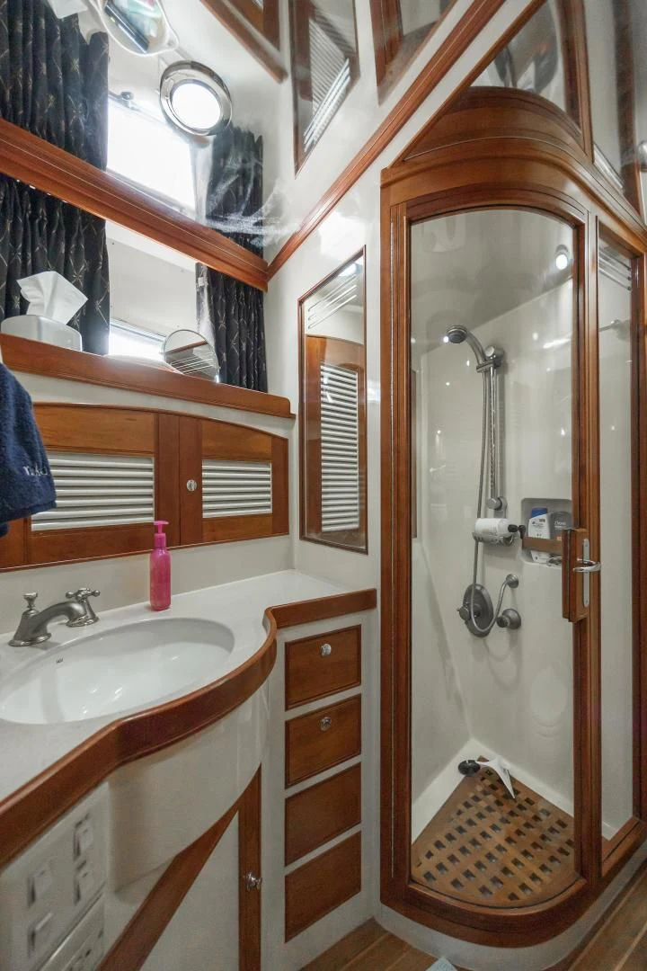 a bathroom with a sink and a mirror aboard DISCONNECTED Yacht for Sale