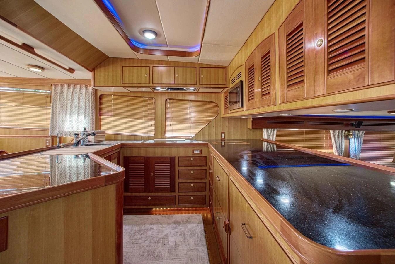 a kitchen with wooden cabinets aboard DISCONNECTED Yacht for Sale