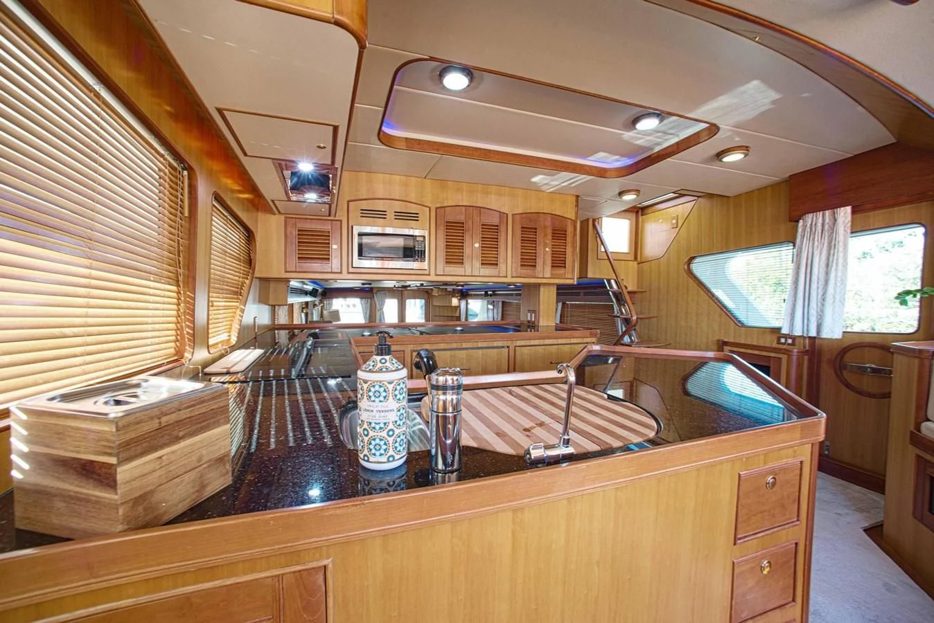 a kitchen with wooden cabinets aboard DISCONNECTED Yacht for Sale