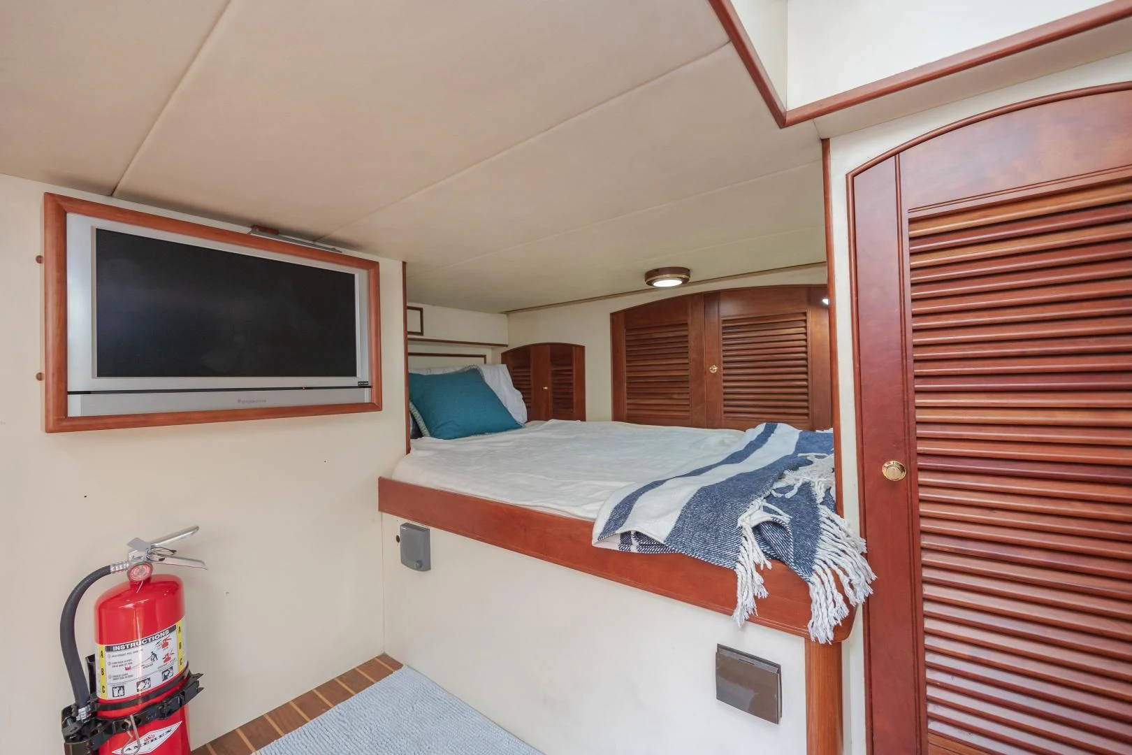 a bedroom with a television and a bed aboard DISCONNECTED Yacht for Sale