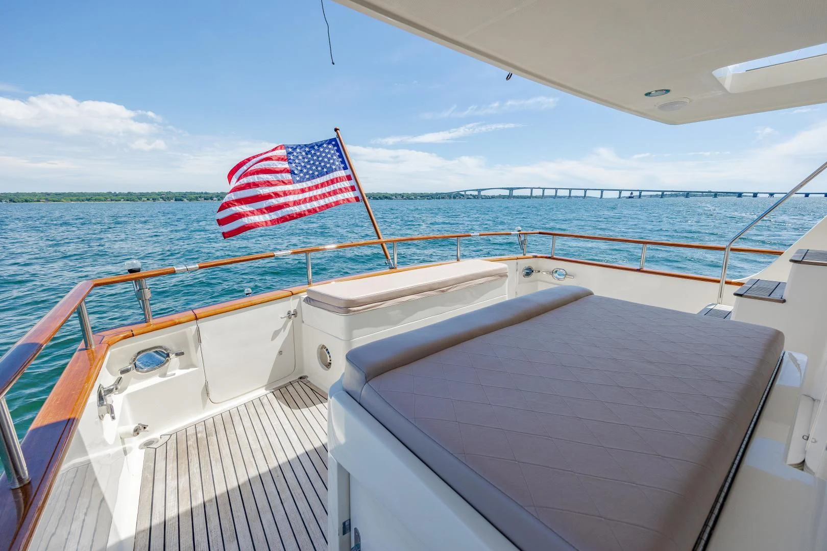 a boat with a flag on the front aboard DISCONNECTED Yacht for Sale
