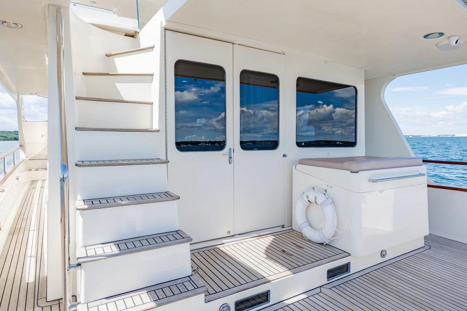 a white room with a large window and a white shelf with a computer aboard DISCONNECTED Yacht for Sale