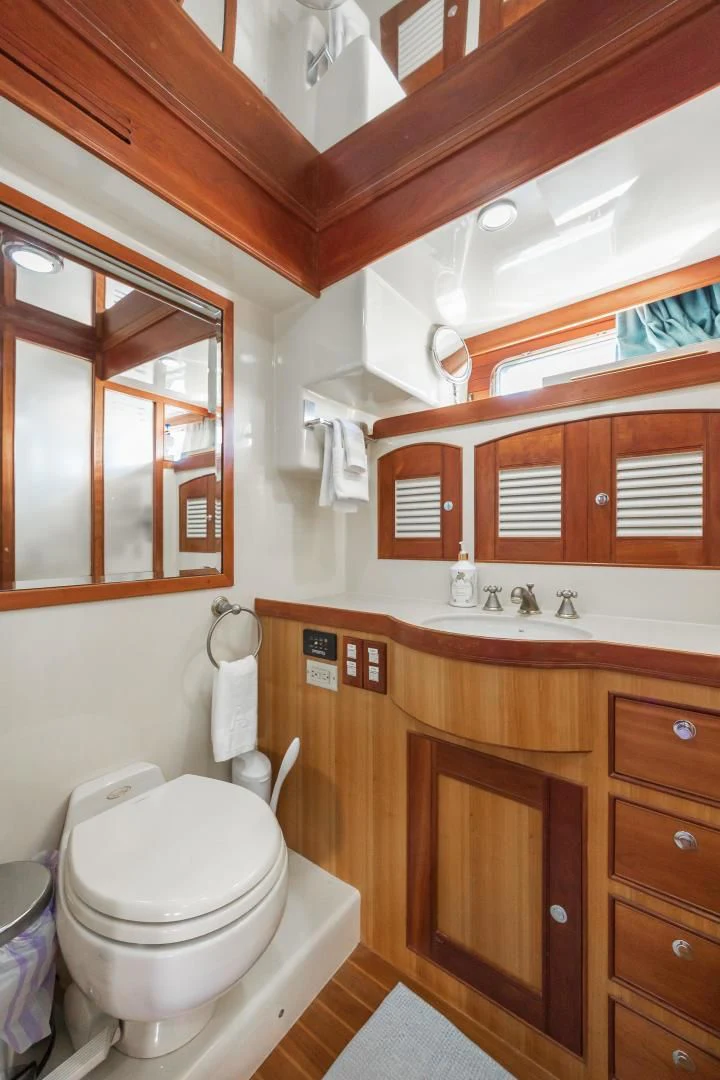 a bathroom with a toilet and a sink aboard DISCONNECTED Yacht for Sale