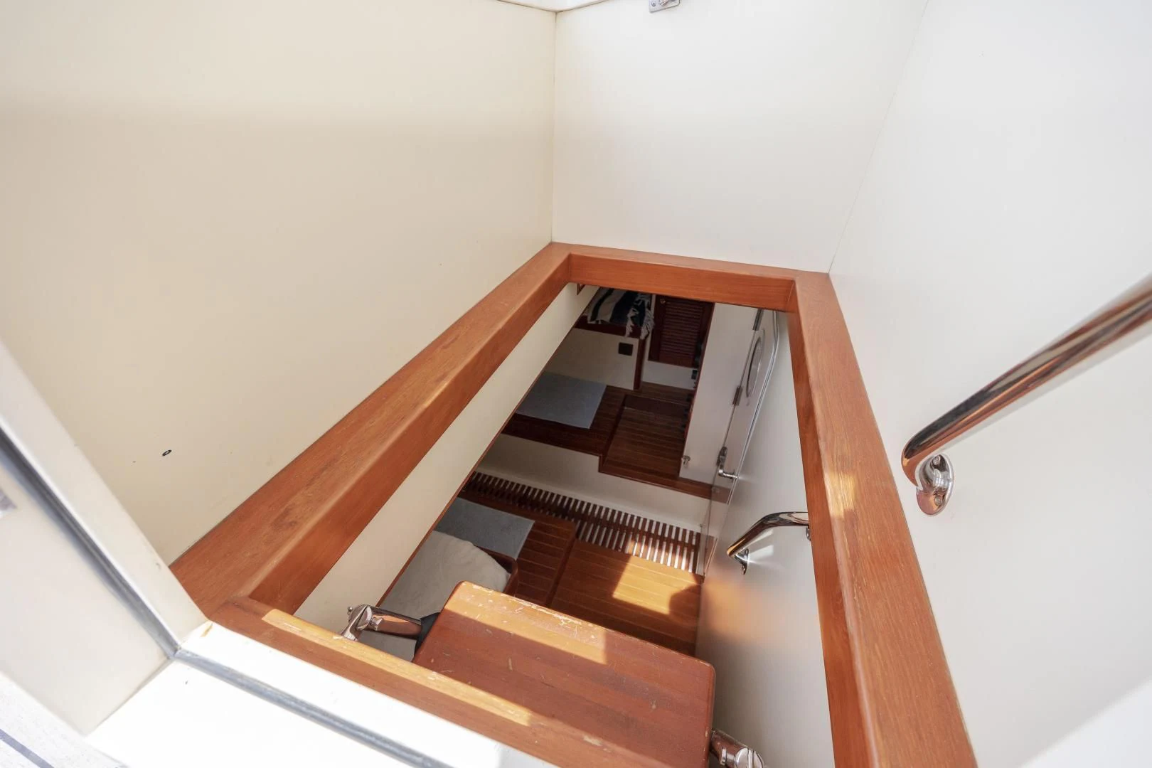 a wooden staircase in a white room aboard DISCONNECTED Yacht for Sale