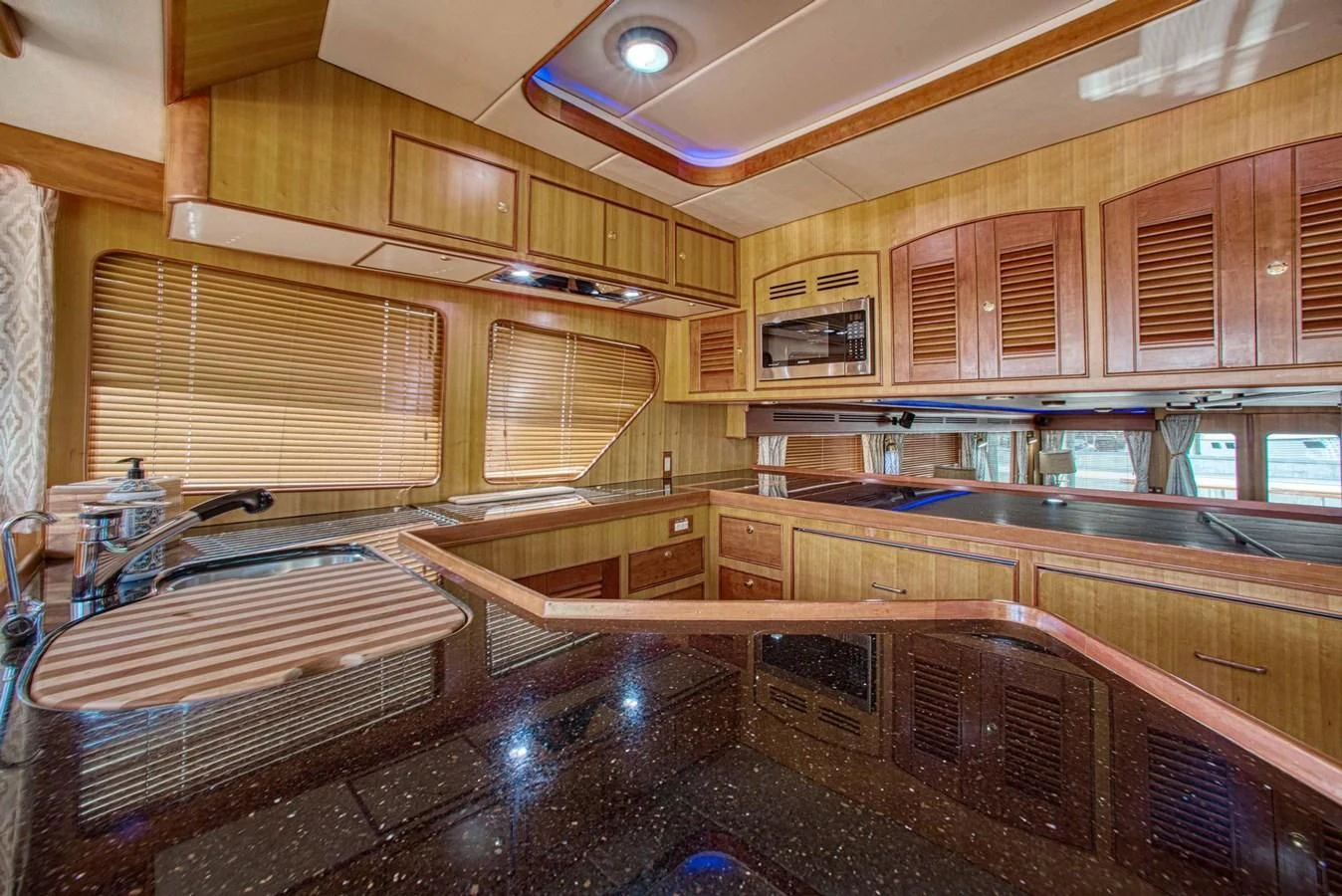 a kitchen with wooden cabinets aboard DISCONNECTED Yacht for Sale
