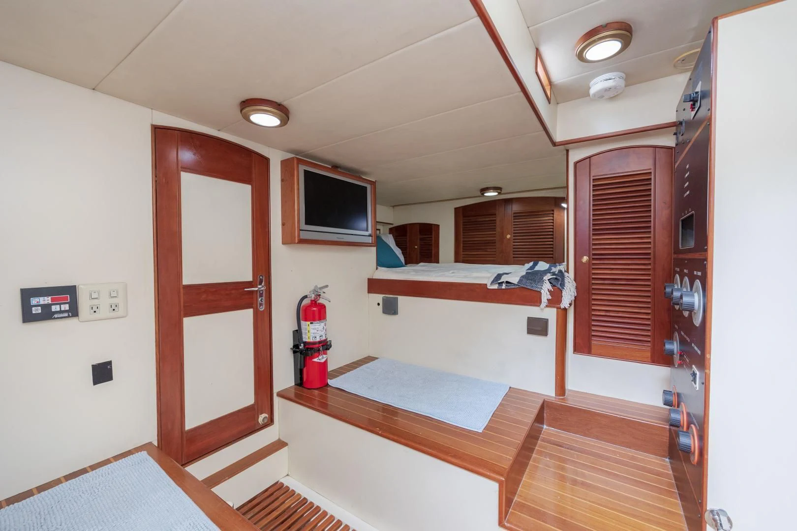 a room with a bed and a television aboard DISCONNECTED Yacht for Sale