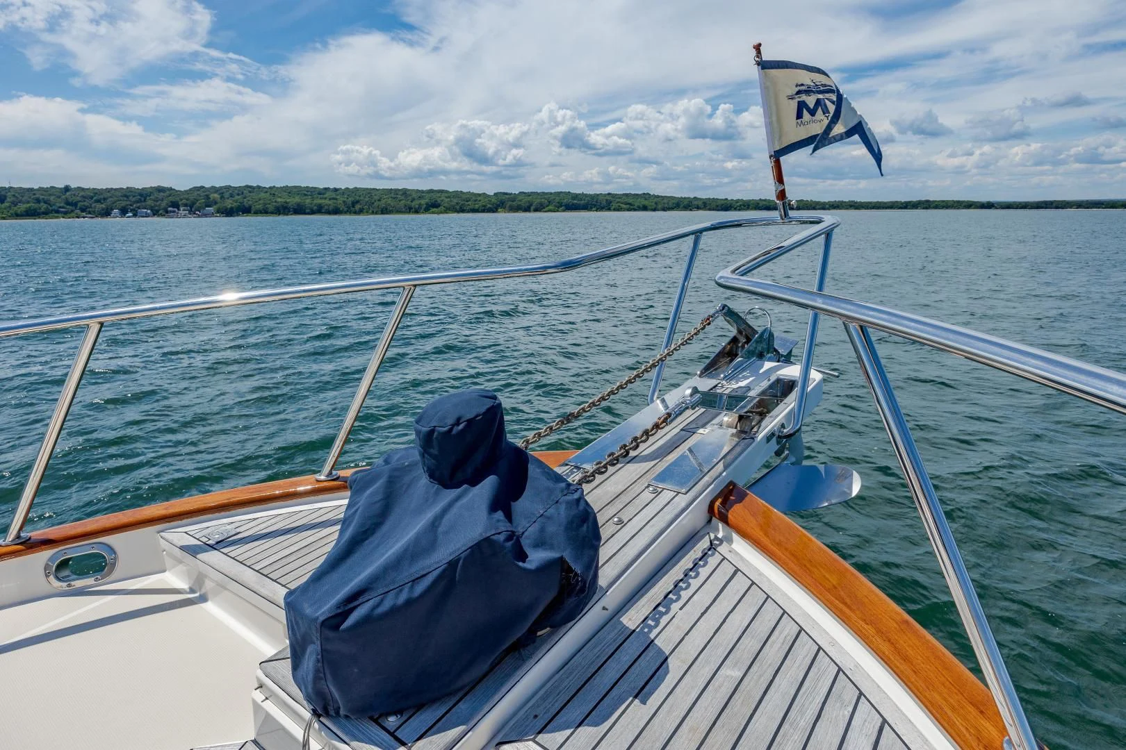 a boat with a flag on the front aboard DISCONNECTED Yacht for Sale